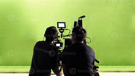 Photographer team and film crew and movie camera. 13383031 Stock Photo at Vecteezy