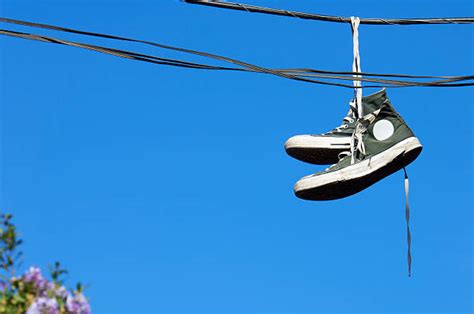 Shoes Hanging From Power Lines Stock Photos, Pictures & Royalty-Free ...