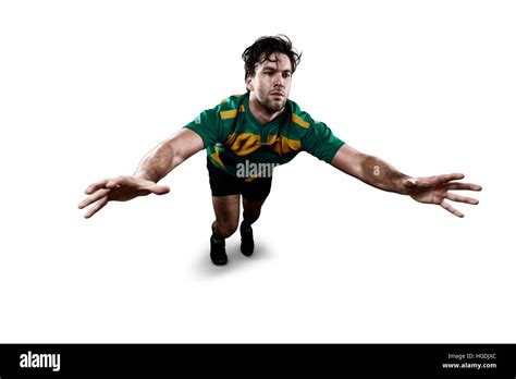 Rugby player in a green and gold uniform giving a tackle. White Background Stock Photo - Alamy