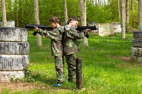 Two Boys Weared in Camouflage Playing Laser Tag in Special Forest Playground Stock Image - Image ...