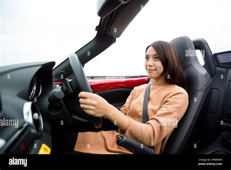 Woman driving convertible car Stock Photo - Alamy