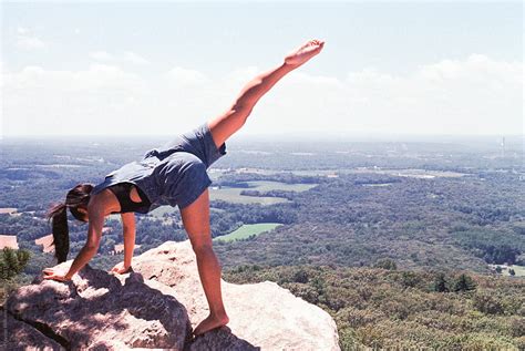 "Girl Practicing Yoga At The Top Of A Mountain Overlook With A Beautiful View During A Bright ...