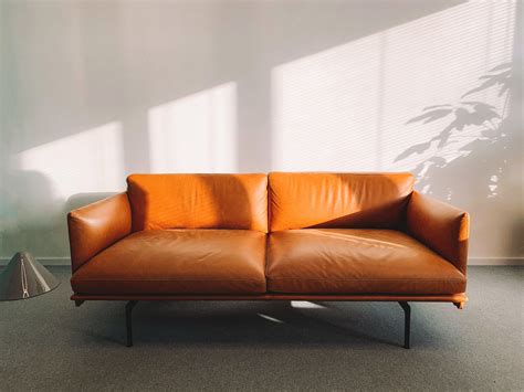 2-seat Orange Leather Sofa Beside Wall · Free Stock Photo