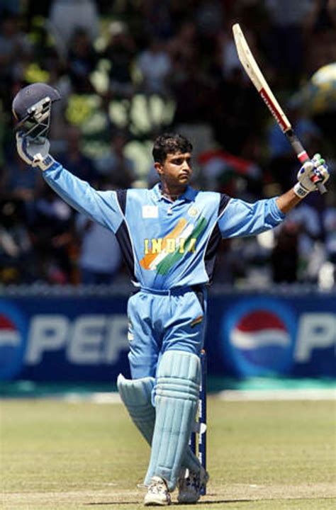 Sourav Ganguly raises his bat to acknowledge the cheering crowd after ...