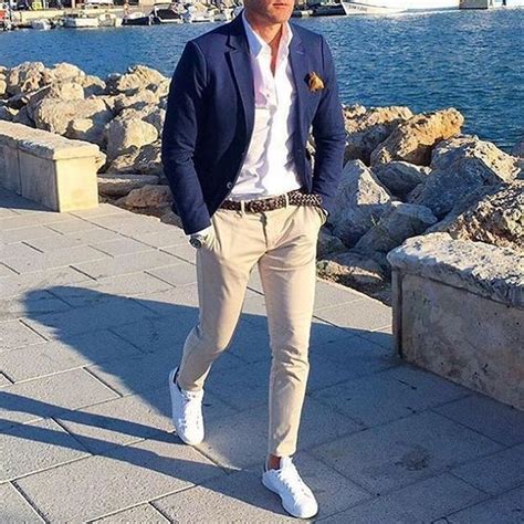 tan pants, a white shirt, a navy blazer and white sneakers that create ...