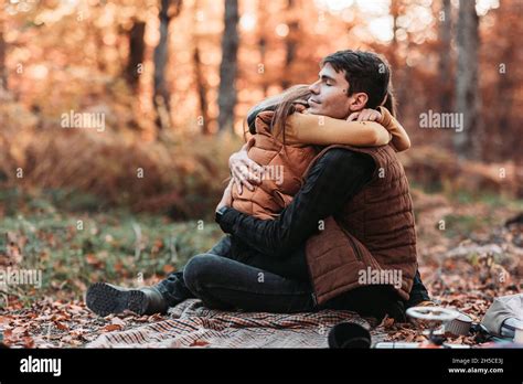 Young, romantic couple in tight embrace in the woods. Autumn time Stock ...