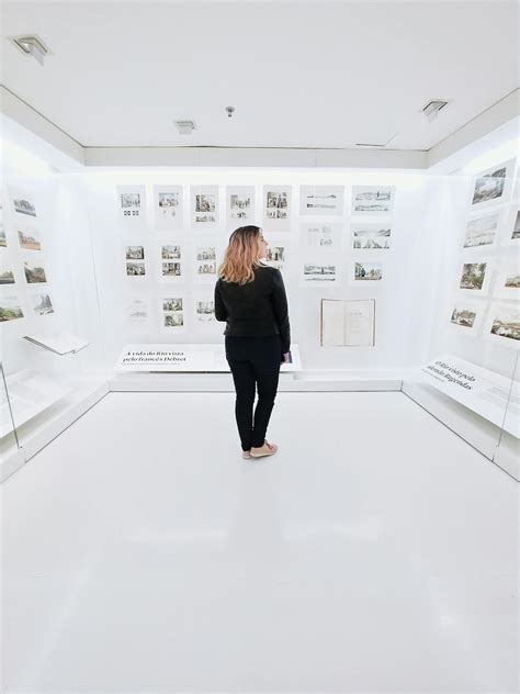 Woman standing in modern museum with pictures on walls · Free Stock Photo