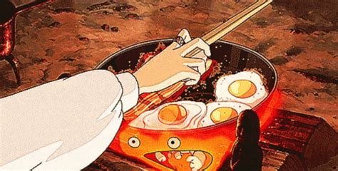 a person cooking eggs in a pan on a stove top with chopsticks next to them