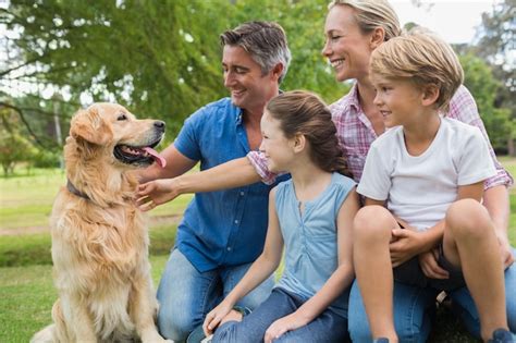 Premium Photo | Happy family in the park with their dog