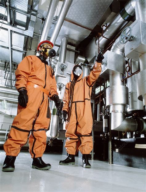 Workers in a factory wearing chemical suits - Stock Image - T870/0220 ...