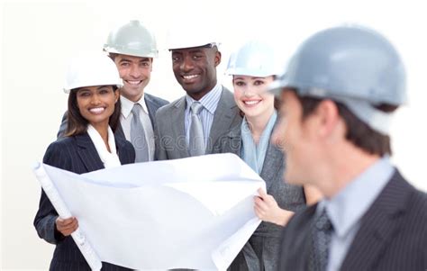 Engineer Smiling at His Team in the Background Stock Photo - Image of ...