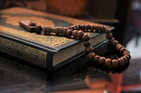 Premium Photo | The open holy quran with tasbih beads