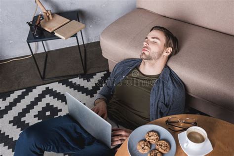 Man Sleeping on Floor in Kitchen Near Open Refrigerator Stock Photo ...