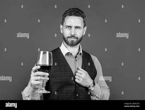 handsome man in formal wear hold glass of red wine for drinking, cheers ...