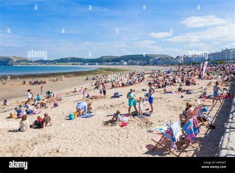 north wales llandudno north wales Llandudno beach holidaymakers adults and children playing on ...