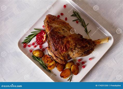 Roast Leg of Lamb with Potatoes, Pomegranate and Rosemary. Stock Photo - Image of oven, lunch ...