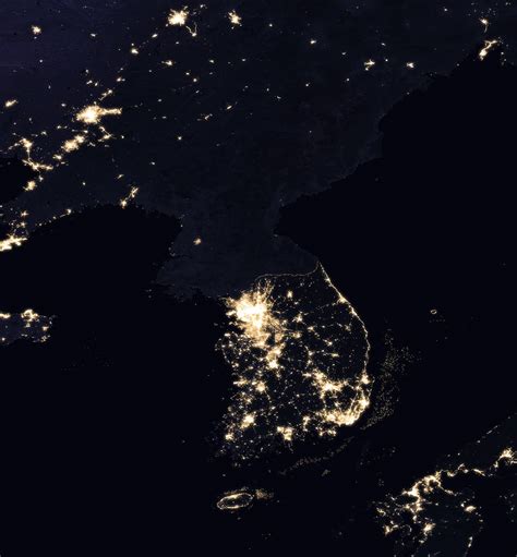 Satellite image of the Korean Peninsula at night, showing North Korea in almost complete ...