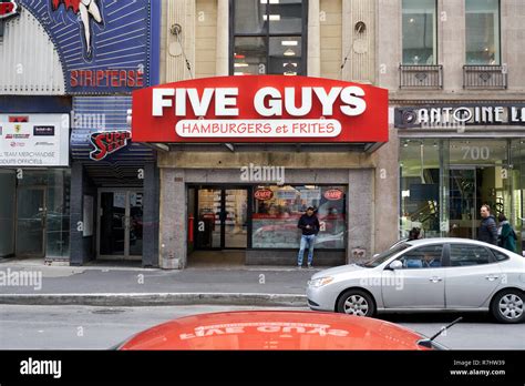 MONTREAL, CANADA - OCTOBER 4, 2018: Five Guys street entrance and logo ...