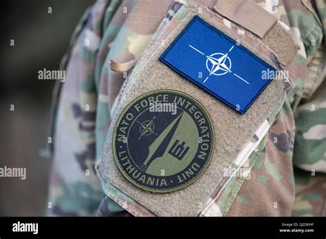 Flag and symbol of NATO, North Atlantic Treaty Organization on a soldier uniform, NATO force ...