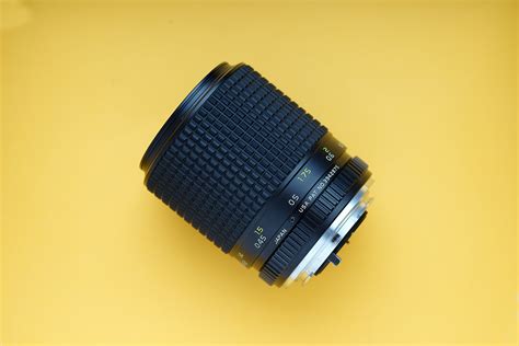 Black Dslr Camera Lens On Yellow Surface · Free Stock Photo