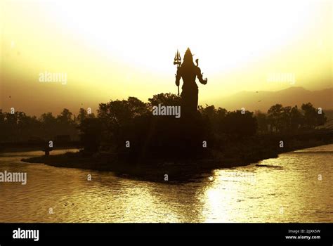 Lord Shiva statue overlooking Haridwar holy town in India at golden ...