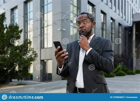 A Serious African American Businessman in a Business Suit is Standing ...