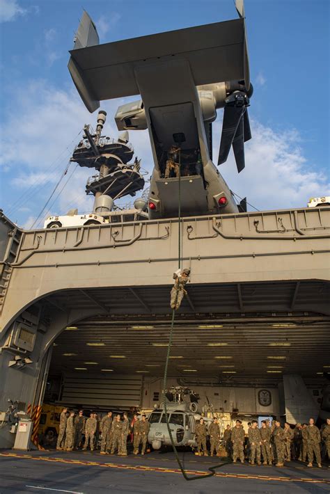 Marines practice fast-roping on the aircraft elevator of the USS ...