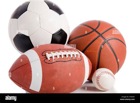 A group of sports balls on a white background, including a baseball, an American football, a ...