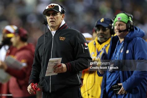 Washington Commanders head coach Ron Rivera looks on from the... News ...