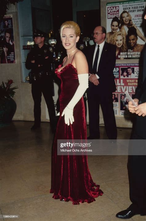 American actress Robyn Griggs, wearing a red velvet evening gown with... News Photo - Getty Images