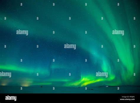 Aurora Borealis spectacular view of the Northern Lights in the sky over Hotel Ranga tourist ...