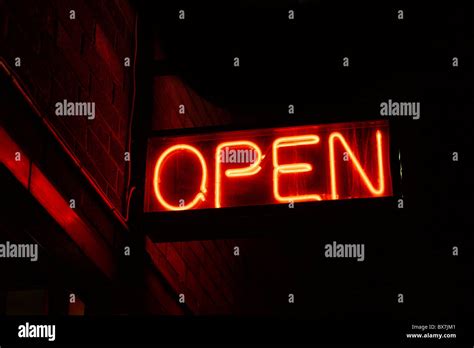 Red open neon sign glowing in the night Stock Photo - Alamy