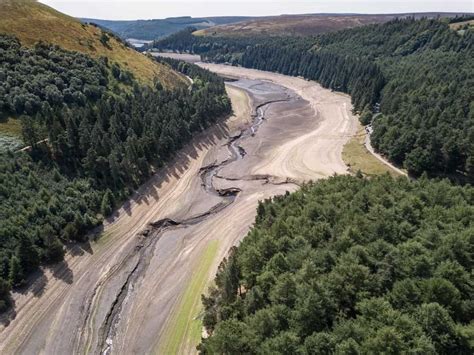 Aerial view of Howden Reservoir lays bare the stark landscape of Britain's parched land