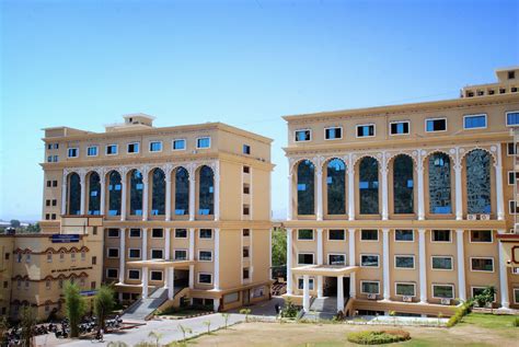 two large buildings with many windows on the front and side of each building are shown