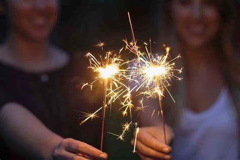 Women holding sparklers in park - StockFreedom - Premium Stock Photography