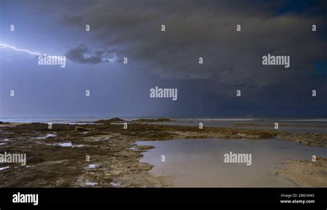 Storm weather with lightning on sea beach Stock Photo - Alamy