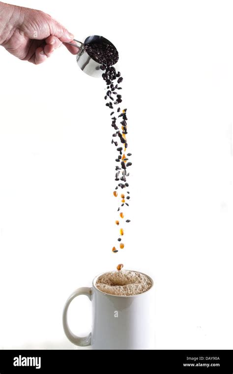 Coffee beans pouring and magically turning into liquid coffee into a white cup Stock Photo - Alamy