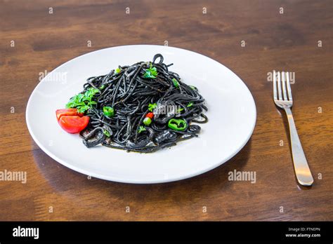 Pasta with squid ink and seafood Stock Photo - Alamy