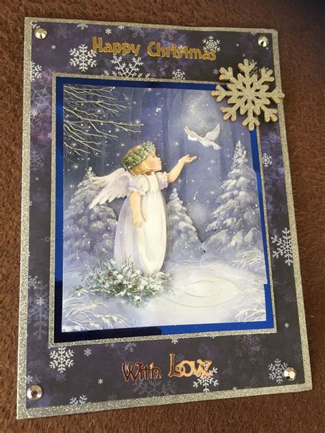 a christmas card with an angel and snowflakes on the bottom, in front ...