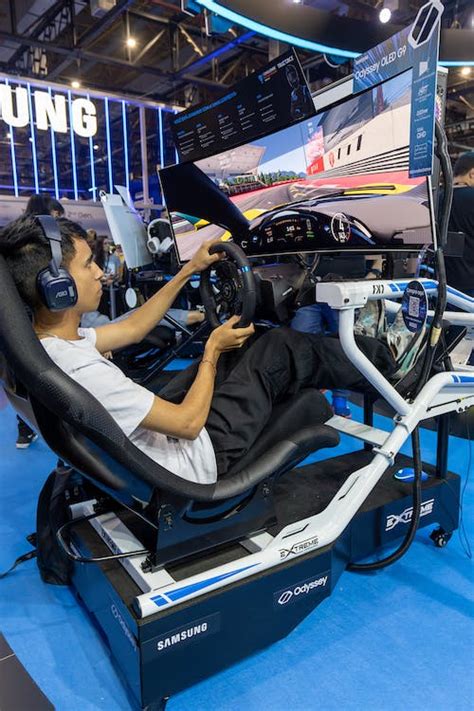 Boy Playing a Racing Game on a Racing Simulator · Free Stock Photo