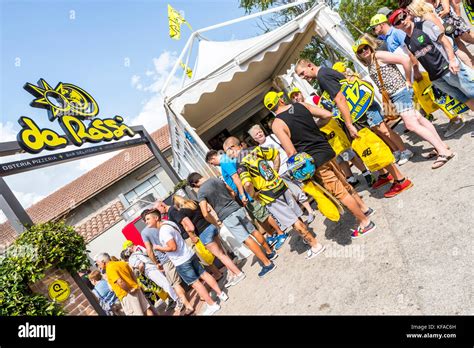 Fans queue at the VR46 merchandise and fan shop. Tavullia, Italy. Hometown of Valentino Rossi ...