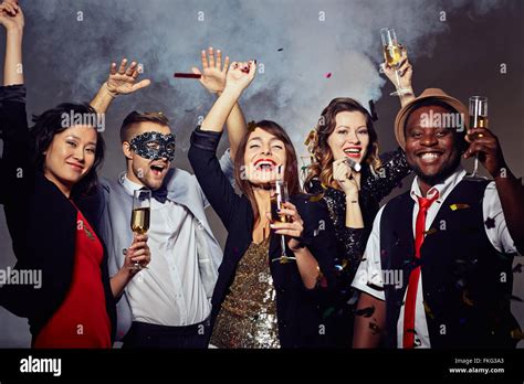 Happy people celebrating the holiday with champagne Stock Photo - Alamy