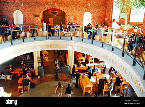 A lunchtime crowd gathers at the tables of the food court in Boston’s ...