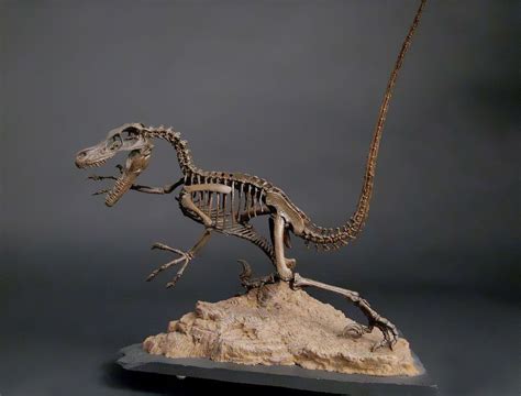 a dinosaur skeleton is standing on top of a rock