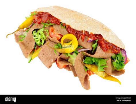 Doner kebab meat and fresh salad in a pitta bread isolated on a white ...