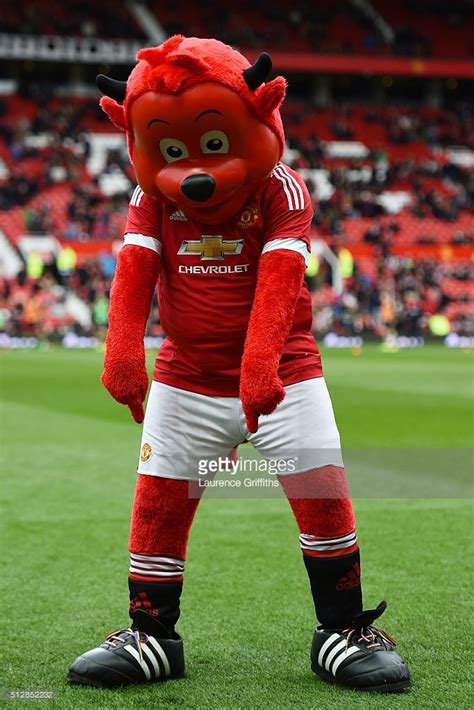 Manchester United mascot Fred the Red points at his rainbow laces ...