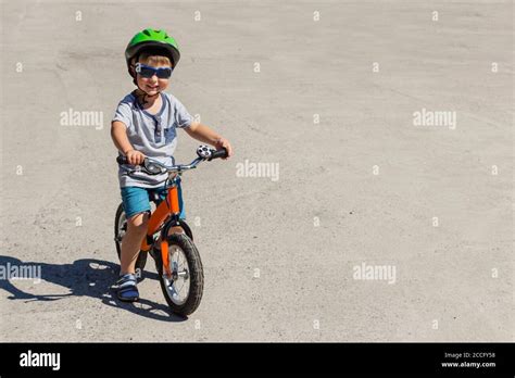 Child in helmet ride balance bike Stock Photo - Alamy