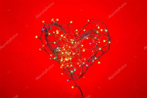 Heart shaped Christmas lights on red Stock Photo by ©dnaumoid 91788580