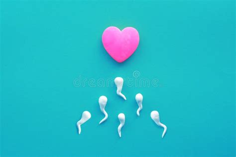 Bright Pink Heart and Sperm on a Yellow Background. Stock Image - Image of medicine, text: 169768475