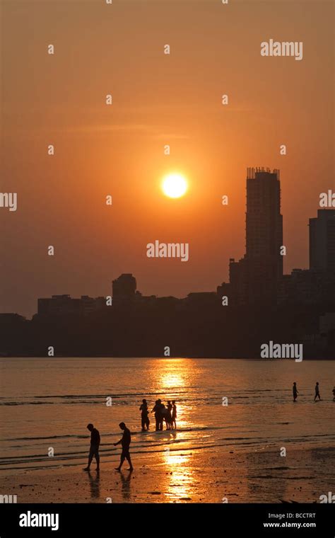 India Mumbai Bombay Chowpatty beach people on beach at sunset view towards Malabar Hill 2009 01 ...